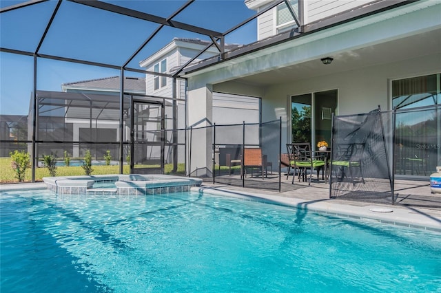 view of swimming pool featuring a patio, glass enclosure, and an in ground hot tub