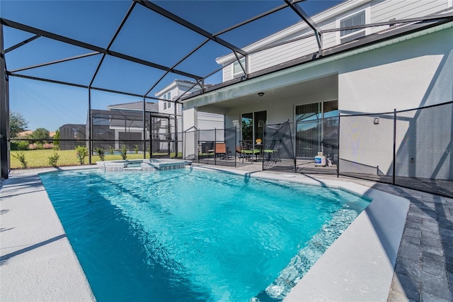 view of pool with glass enclosure, a patio, and an in ground hot tub