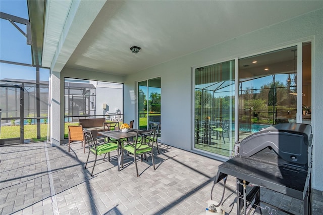 sunroom / solarium featuring a wealth of natural light and a pool