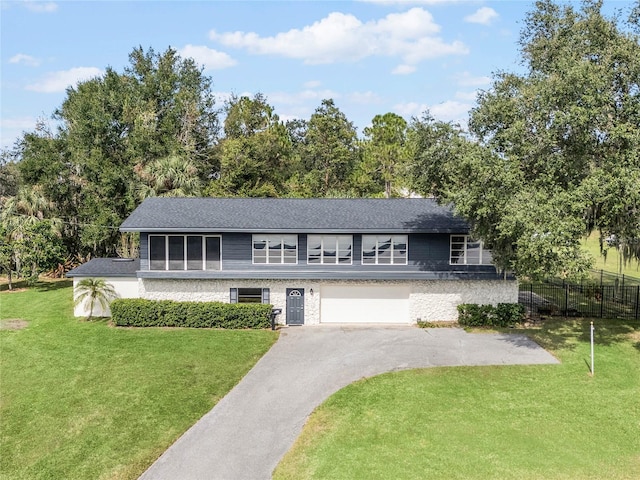 view of front of property featuring a front lawn and a garage