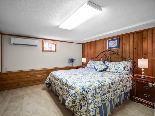 bedroom featuring an AC wall unit, wooden walls, and light colored carpet