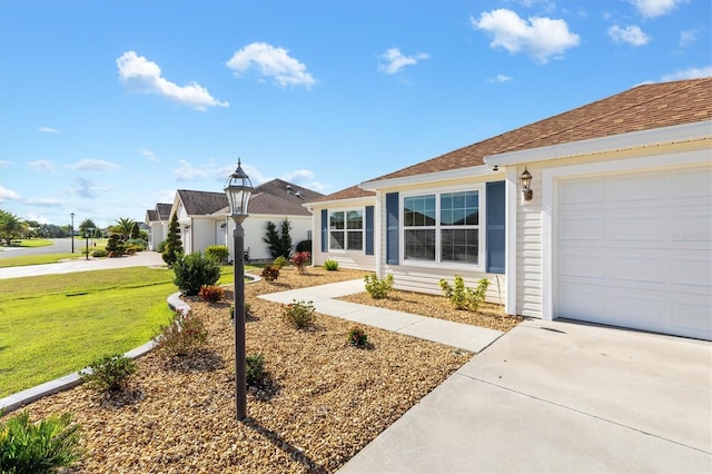 single story home with a front yard and a garage