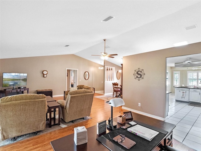 tiled living room featuring ceiling fan and lofted ceiling