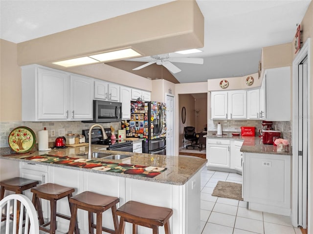 kitchen featuring white cabinets, appliances with stainless steel finishes, and kitchen peninsula