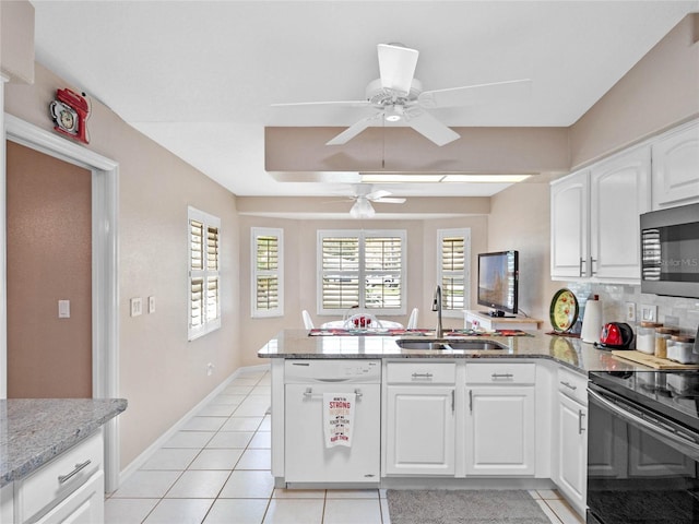 kitchen featuring white cabinetry, sink, kitchen peninsula, white dishwasher, and black electric range