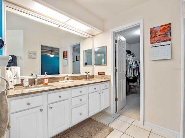 bathroom featuring vanity, a textured ceiling, tile patterned flooring, and ceiling fan