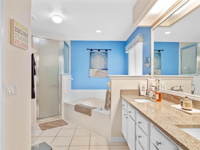 bathroom featuring separate shower and tub, a textured ceiling, and tile patterned floors