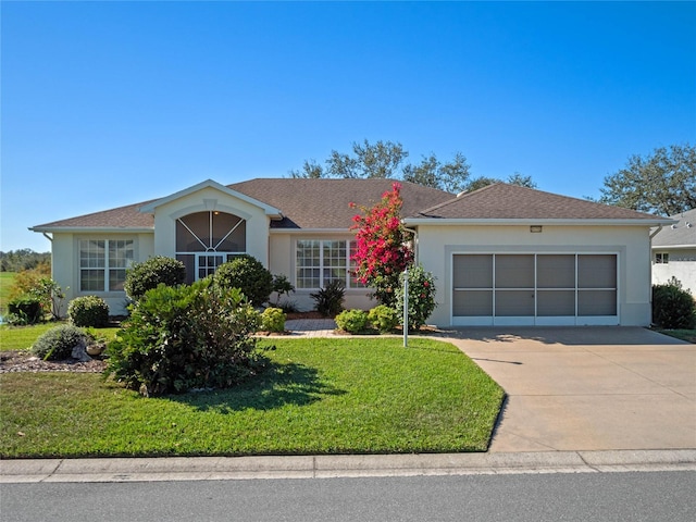 ranch-style home with a garage and a front lawn