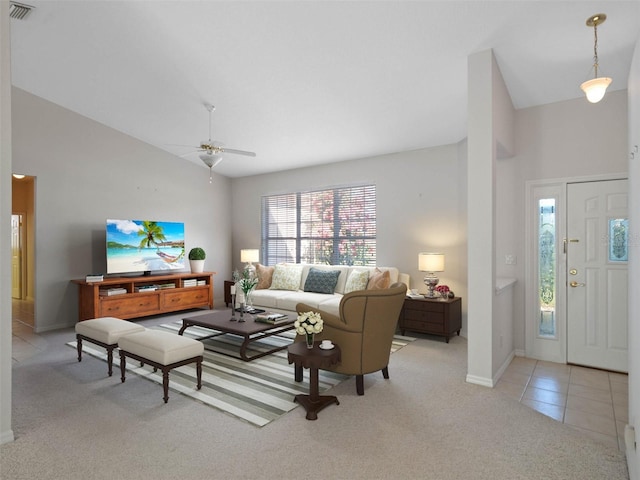 living room with ceiling fan, high vaulted ceiling, and light colored carpet