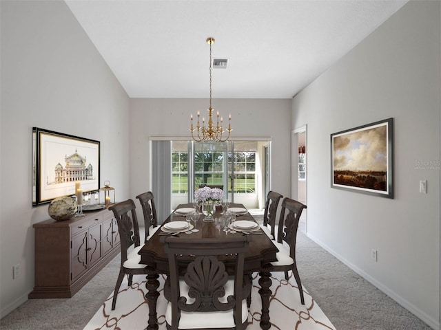 dining space with light colored carpet and a chandelier