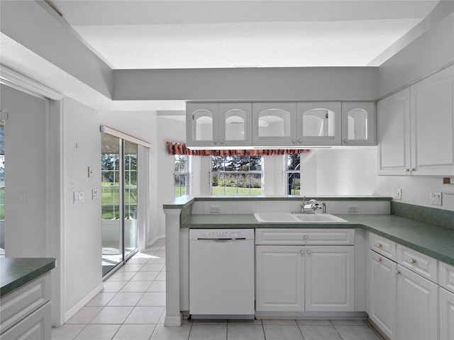 kitchen featuring a wealth of natural light, dishwasher, sink, kitchen peninsula, and white cabinets