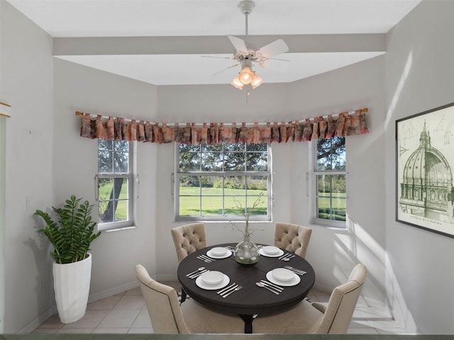 dining space with light tile patterned floors and ceiling fan