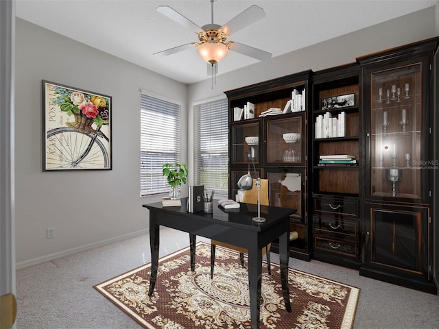 home office featuring ceiling fan and light carpet