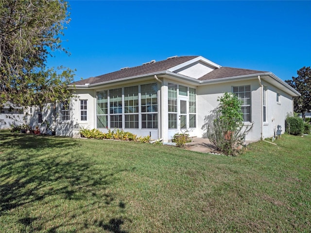 rear view of property with a yard