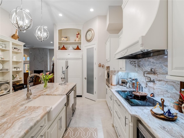 kitchen featuring light stone counters, backsplash, white cabinets, custom range hood, and appliances with stainless steel finishes