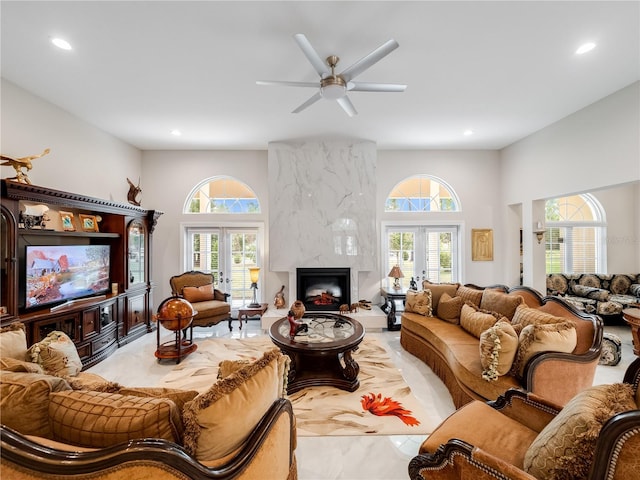 living room with a wealth of natural light, french doors, and ceiling fan