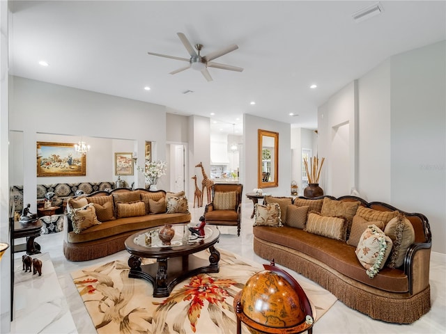 living room with ceiling fan with notable chandelier