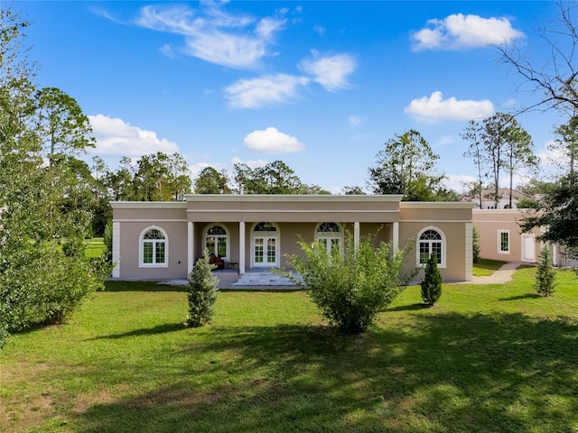 back of house with a lawn and french doors