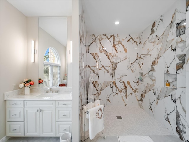 bathroom with vanity, walk in shower, and tile walls