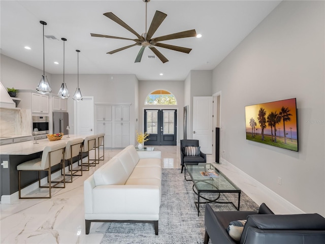 living room with ceiling fan and french doors