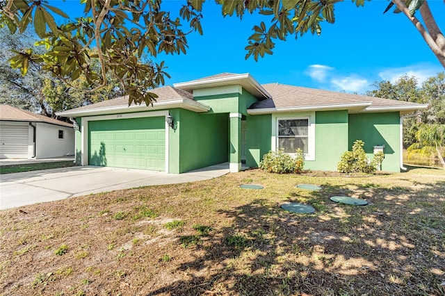 single story home featuring driveway, a shingled roof, an attached garage, and stucco siding