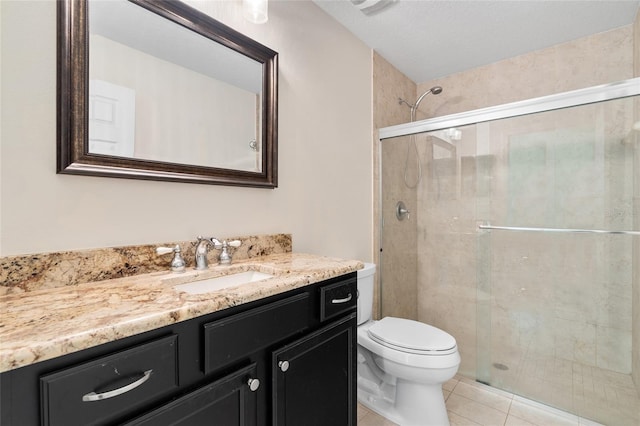 bathroom with toilet, a stall shower, tile patterned floors, and vanity