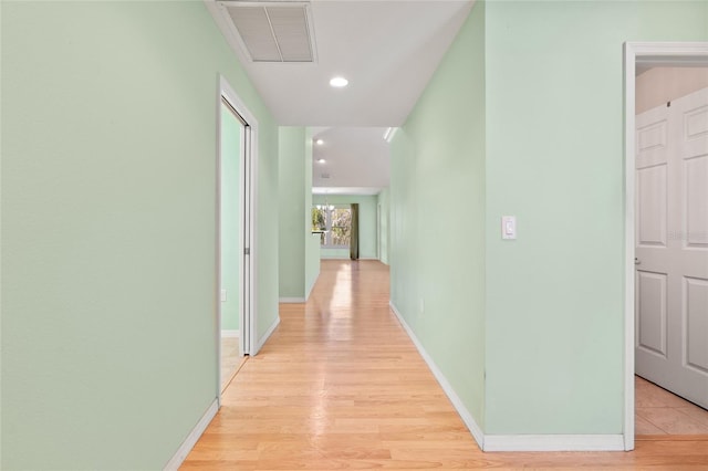 hall with baseboards, recessed lighting, visible vents, and light wood-style floors