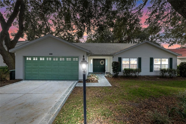 ranch-style home featuring a yard and a garage