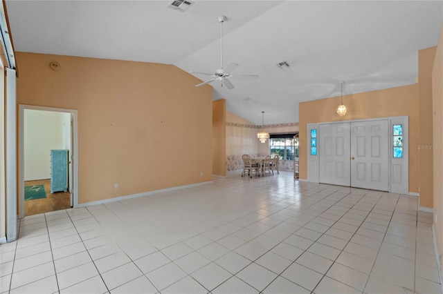 tiled foyer entrance with ceiling fan and high vaulted ceiling