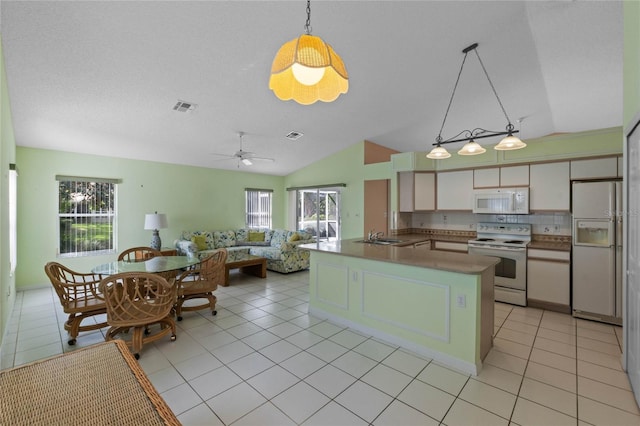 kitchen featuring pendant lighting, white appliances, vaulted ceiling, ceiling fan, and light tile patterned floors