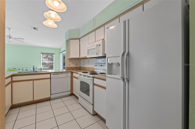 kitchen with ceiling fan, sink, kitchen peninsula, white appliances, and light tile patterned floors