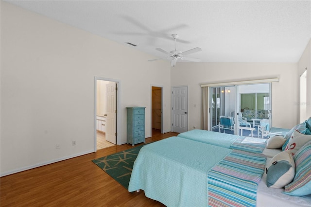 bedroom with access to exterior, ensuite bath, ceiling fan, lofted ceiling, and hardwood / wood-style flooring