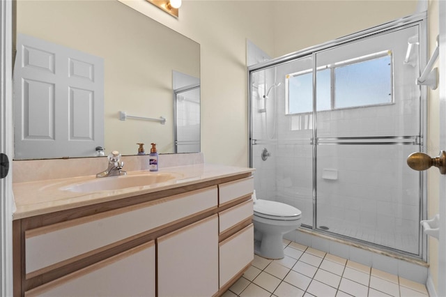 bathroom featuring toilet, vanity, tile patterned floors, and walk in shower