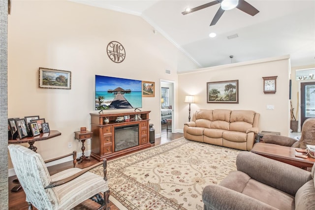 living room with ornamental molding, lofted ceiling, wood-type flooring, and ceiling fan