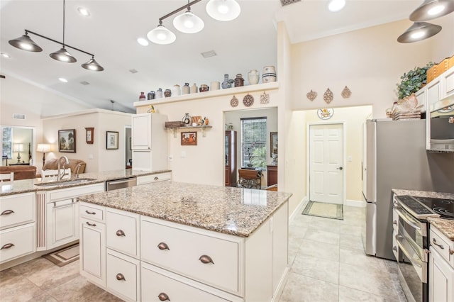 kitchen with sink, white cabinetry, a center island, pendant lighting, and stainless steel appliances