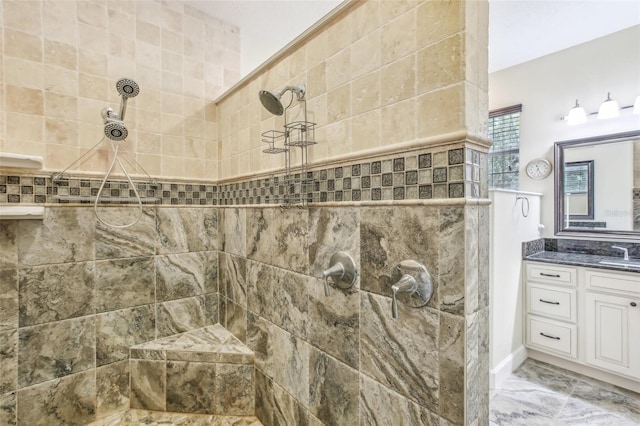 bathroom featuring vanity and tiled shower