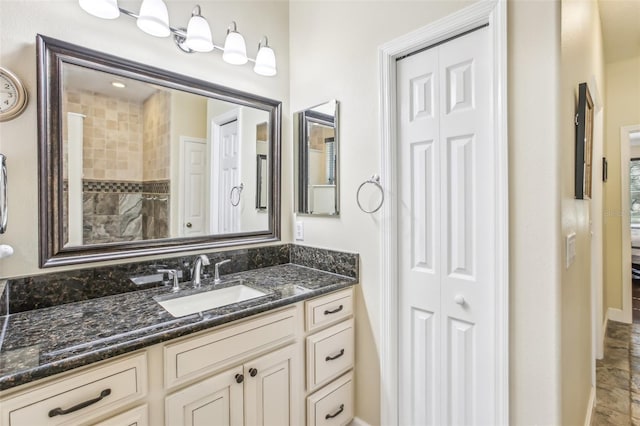 bathroom with vanity and tiled shower