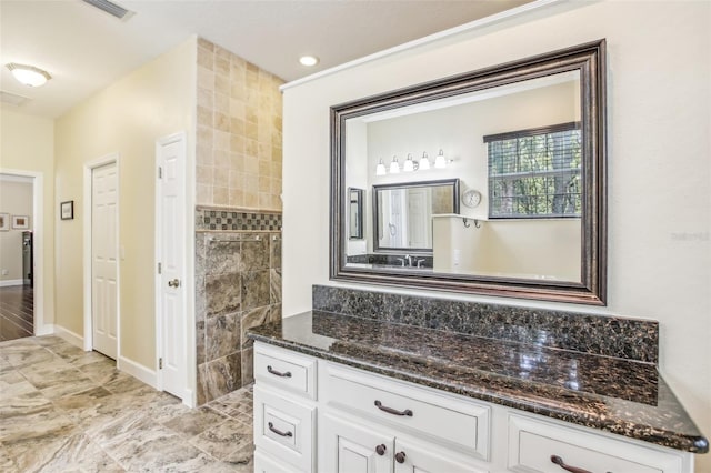 bathroom featuring vanity and a shower