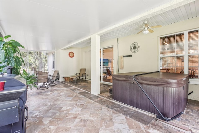 interior space with a hot tub and ceiling fan