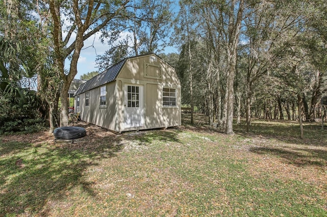 view of outbuilding featuring a yard