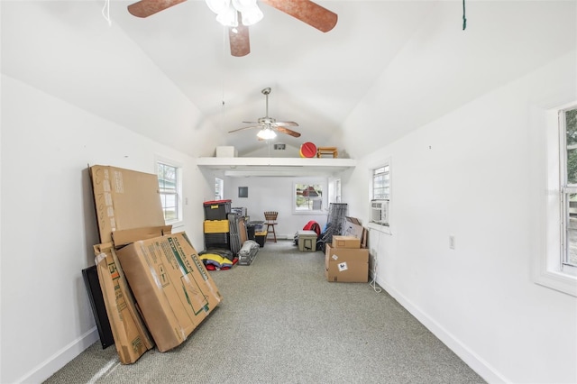 interior space with carpet floors, lofted ceiling, and a healthy amount of sunlight