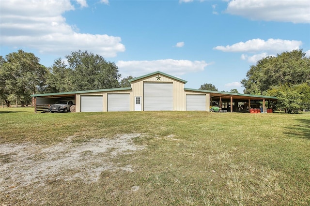 garage with a carport and a lawn