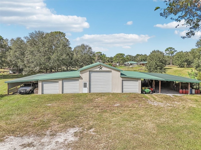 garage featuring a carport and a lawn