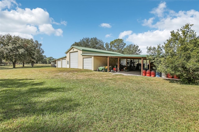 view of yard featuring an outbuilding and a garage