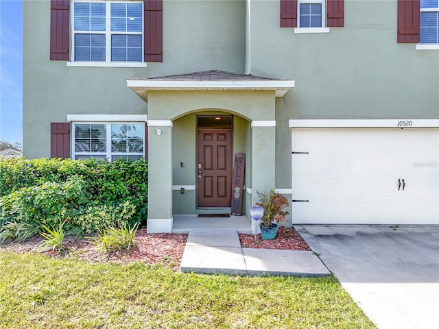 view of exterior entry with a garage