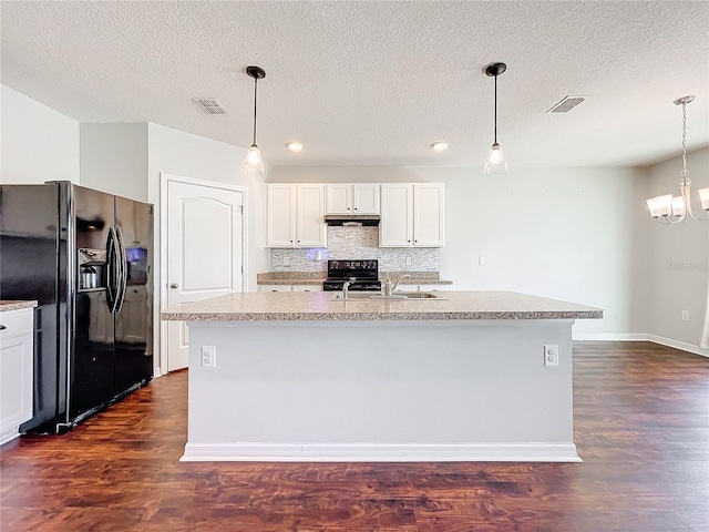 kitchen with an island with sink, white cabinets, black appliances, and dark hardwood / wood-style floors