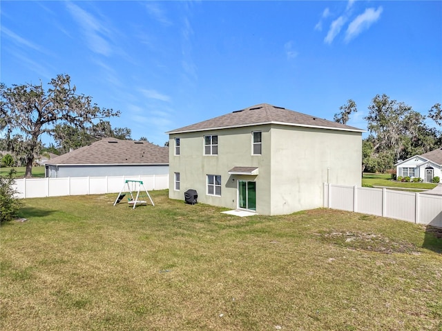 back of house featuring a yard