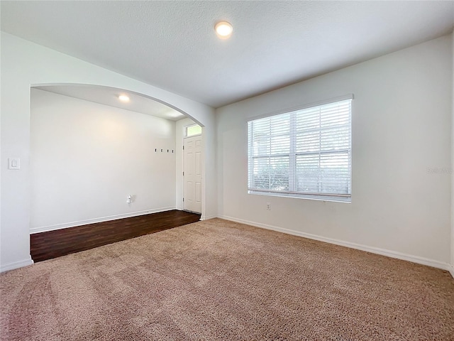 spare room with hardwood / wood-style floors and a textured ceiling