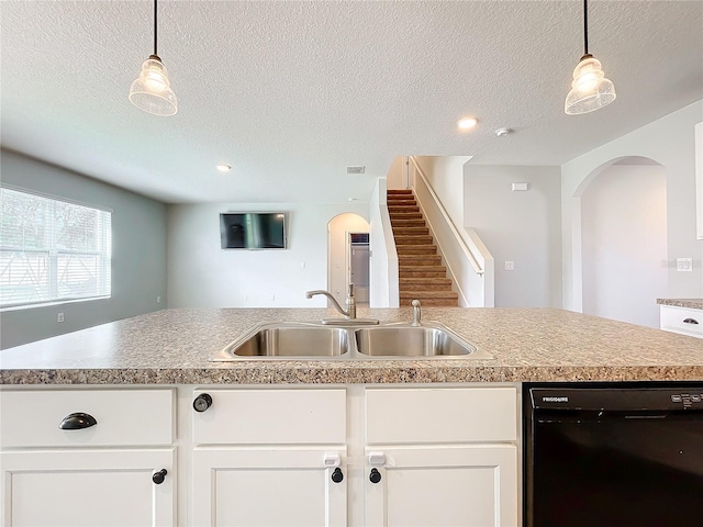 kitchen with a kitchen island with sink, sink, decorative light fixtures, and black dishwasher