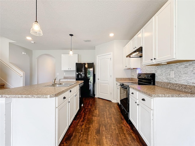 kitchen with white cabinetry, sink, dark hardwood / wood-style floors, decorative light fixtures, and black appliances